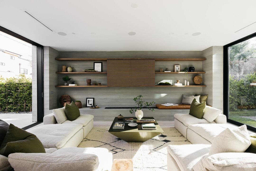 Contemporary living room with floor-to-ceiling windows and comfortable white seating